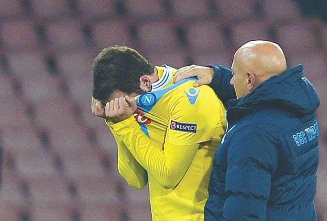 Napoli striker Gonzalo Higuain is inconsolable at the end of their Champions League encounter against Arsenal at the San Paolo Stadium on Wednesday. Photo: AFP