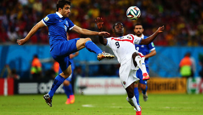 Sokratis Papastathopoulos of Greece challenges Joel Campbell of Costa Rica during their 2014 FIFA World Cup Round of 16 match at Arena Pernambuco on June 29, 2014 in Recife, Brazil. Photo: Getty Images