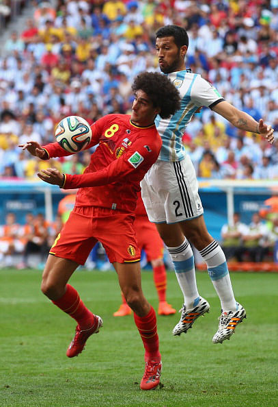 Marouane Fellaini of Belgium controls the ball against Ezequiel Garay of Argentina during their World Cup quarter-final match at the Mane Garrincha National Stadium in Brasilia on July 5, 2014. Photo: Getty Images