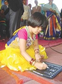A child writes her first letters in Pabna. Photo: Star 