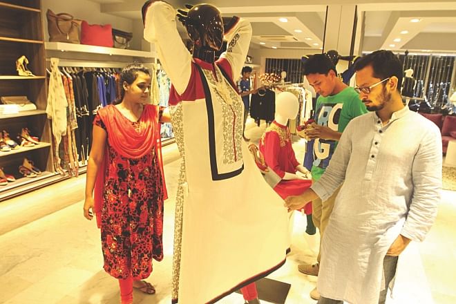 A man looks at a dress at the store of Noir, owned by leading garment maker Evince, in Banani, Dhaka.  Photo: Palash Khan