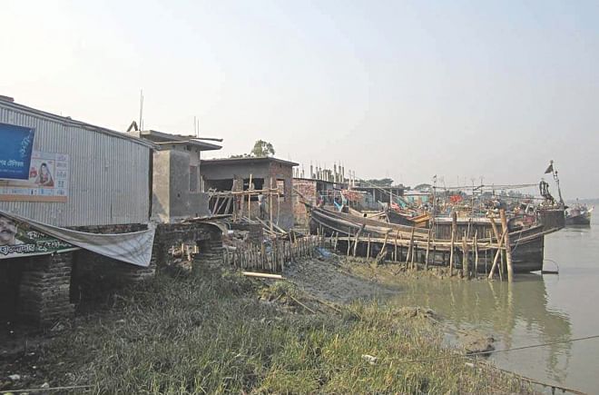A section of  local influential people have erected a good number of illegal structures, encroaching upon the Shibbaria River in Kalapara upazila of Patuakhali. Photo: Star
