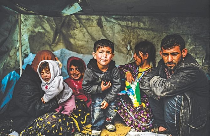 A Syrian refugee family from Aleppo stay under a shelter during a rainy day, in Istanbul, March 2014 Source: UNHCR