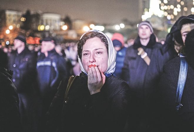 A woman cries as she stays on Kiev's Independence Square, yesterday. Photo: AFP