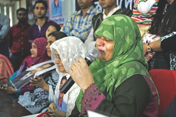 Mother of Masum, one of the eight people missing since being abducted allegedly by law enforcers exactly a year ago, fails to hold back tears as she speaks at a press conference of the families of forced disappearance victims at the Jatiya Press Club in the capital yesterday. PHOTO: Palash Khan