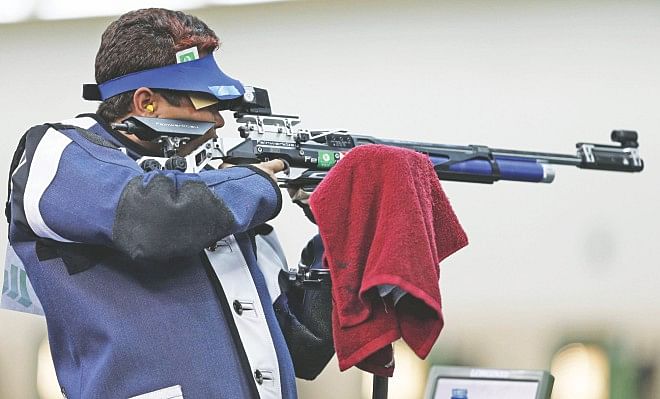 Bangladesh's Abdullah Hel Baki aims at the target during the men's 10m Air Rifle event of the 2014 Commonwealth Games at the Barry Buddon Shooting Centre in Glasgow, Scotland yesterday.  PHOTO: REUTERS