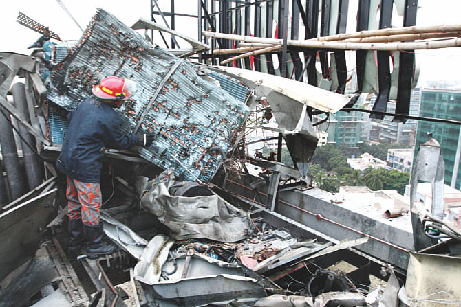 A firefighter inspects the wreckage of a Gulshan hotel where an air conditioner exploded yesterday.  Photo: Star