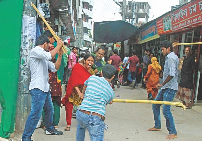 Activists of the ruling Awami League beat up a Tuba Group worker in the capital yesterday as workers demonstrated for arrears.  Photo: Amran Hossain 