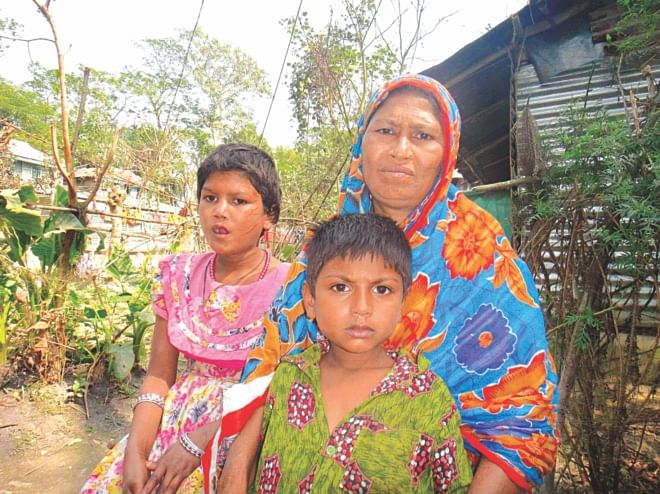 Aduri with her mother and brother at their Jainkathi village home in Patuakhali Sadar upazila. PHOTO: STAR