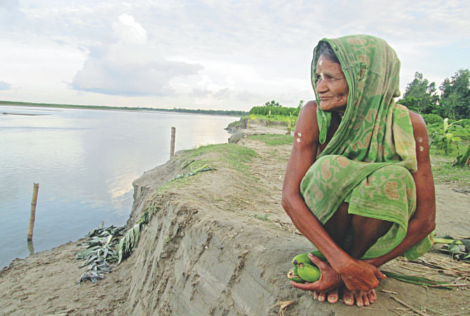 Mala Rani Barmoni, the 88 year old widow of Dharla river basin, has lost all her assets to river erosion. Photo: Star