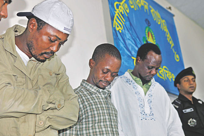 Three African nationals detained by Rab in the capital's Moghbazar for illegally staying in Bangladesh. One of them is originally from Chad and the others are from Liberia. Photo: STAR
