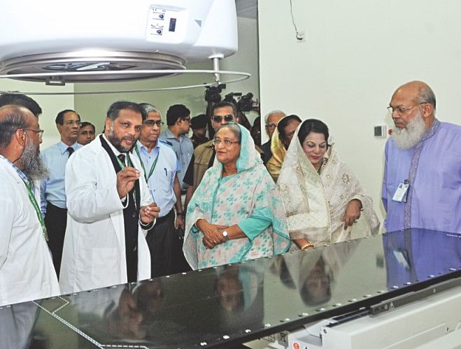 Sheikh Hasina talks to the hospital officials and inspects the medical equipment during a walk around it. Photo: Star
