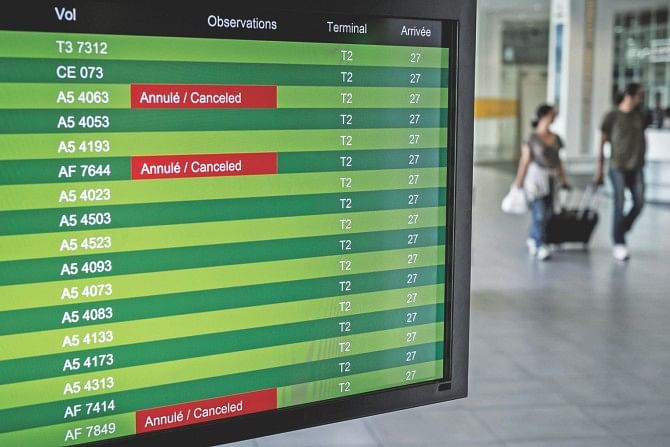 Timetables display cancelled Air France flights at the Lyon-Saint-Exupery airport yesterday. French flag carrier Air France said it would be forced to scrap half its flights yesterday as pilots strike in protest at the company's plan to develop its low-cost subsidiary. The screens read ‘Air France pilots strike, planned disruptions’. Photo: AFP 