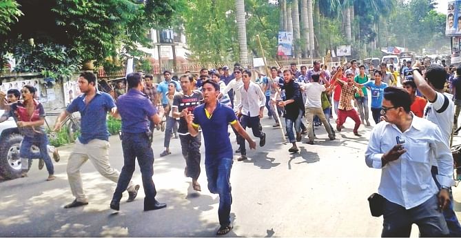 Violent Bangladesh Chhatra League activists give chase to another faction of the pro-Awami League student body, not in picture, before the judge's court premises on Bangabandhu Road in Gopalganj around noon yesterday. Photo: Star
