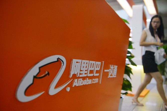 A woman walks past the Alibaba booth during an exhibition in Hangzhou, east China's Zhejiang province. Photo: AFP