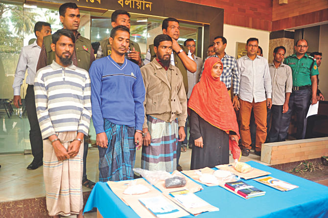 Detective Branch of police yesterday shows the media the alleged Jama'atul Mujahideen Bangladesh operatives captured in raids in Sadarghat area in the capital. The female on the right is the wife of Sajid, who is suspected of carrying out the Burdwan blast in India in October. Photo: Firoz Ahmed