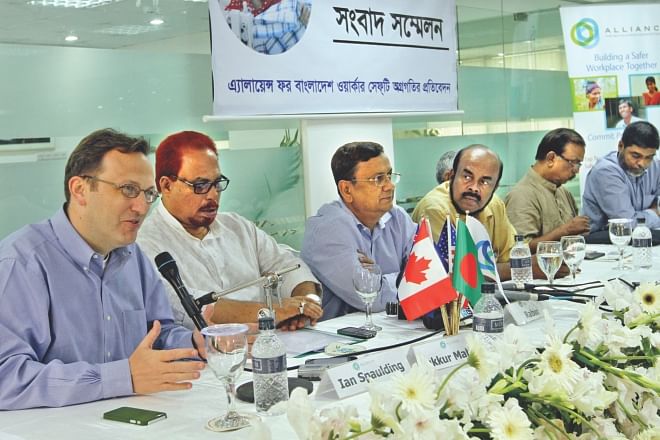 Left, Ian Spaulding, adviser to Alliance for Bangladesh Worker Safety, speaks at a press briefing in Dhaka yesterday. Third from left, Rabin Mesbah, managing director of the Alliance, was also present.  Photo: Star 