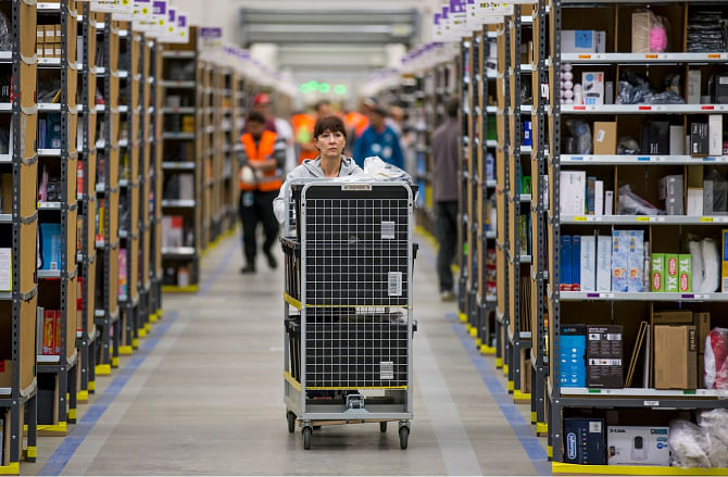 A worker puts together orders at the Amazon logistics centre in Brieselang, Germany. Photo: Reuters/File