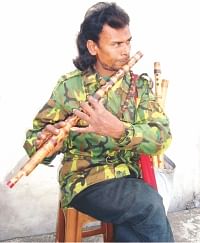 Amir Hamza playing his flute at a market in Jhenidah. PHOTO: STAR