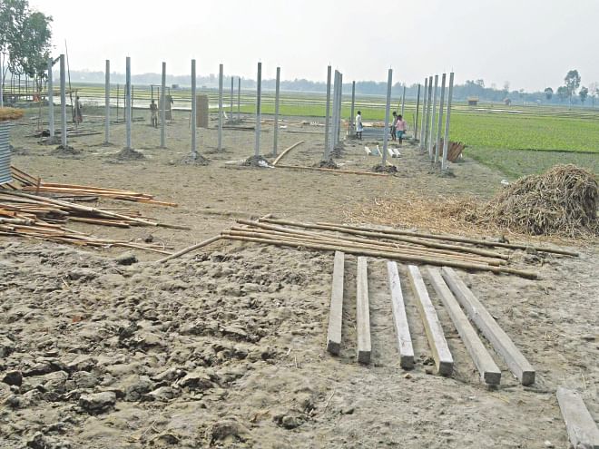 An Awami Leaguer is getting structures built on a piece of land that belongs to Bhabani Kanta Sen at Rasulpur of Patgram in Lalmonirhat. The Hindu family had to seek help of the police to ward off the aggression by the ruling party man. Photo: Star