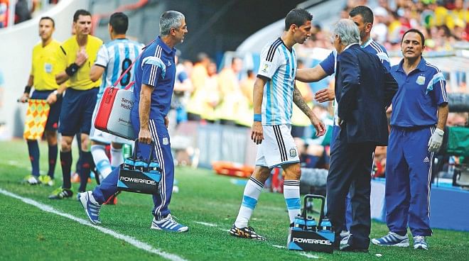 Argentina midfielder Angel Di Maria (C) leaves the field of play after picking up an injury during their World Cup quarterfinal against Belgium at Estadio Nacional in Brasilia on Saturday. PHOTO: REUTERS