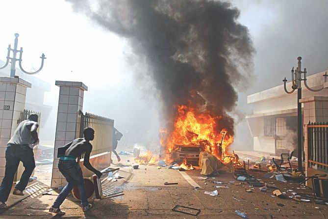 Burkina Faso's President Blaise Compaore was toppled yesterday as the army took power after protesters set parliament ablaze in a popular uprising against the veteran leader's 27-year-rule. The demonstrators earlier forced the government to scrap a vote on controversial plans to allow Compaore to extend his reign, with tens of thousands of people joining a mass rally in the capital Ouagadougou calling for the strongman to go. Photo: AFP