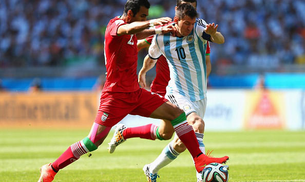 Lionel Messi of Argentina and Mehrdad Pooladi of Iran compete for the ball during the 2014 FIFA World Cup Brazil Group F match between Argentina and Iran at Estadio Mineirao on June 21, 2014 in Belo Horizonte, Brazil. Photo: Getty Images