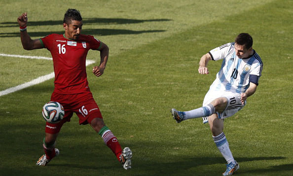 Argentina's forward and captain Lionel Messi (R) shoots past Iran's forward Reza Ghoochannejhad to score during the Group F football match between Argentina and Iran at the Mineirao Stadium in Belo Horizonte during the 2014 FIFA World Cup in Brazil on June 21, 2014. Photo: Getty Images
