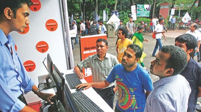 Visitors gather at Aarong's stall at the three-day e-commerce fair that began at Begum Sufia Kamal National Public Library in Dhaka yesterday.  Photo: Star