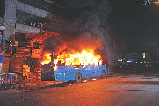 A bus of the public administration ministry burns at Paltan in the capital December 28, 2014, after it was set on fire allegedly by pickets during a nationwide hartal sponsored by the BNP-led 20-party alliance yesterday. Photo: Star