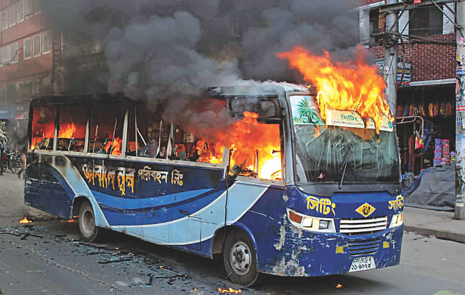 A bus burns on Rokeya Sarani at Sheorapara in the capital yesterday after alleged supporters of the BNP-led 20-party alliance's nationwide indefinite blockade set it on fire. Over 125 vehicles have been torched since January 5. Photo: Collected