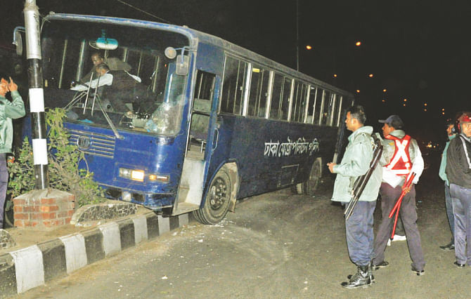 Alleged blockade supporters hurled a crude bomb at this police bus, causing the driver to lose control and go over the central reservation near Matshya Bhaban in the capital yesterday. Photo: Palash Khan