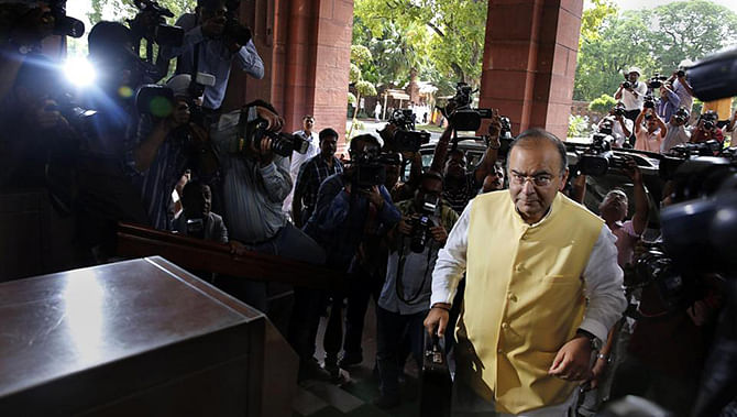 Indian Finance Minister Arun Jaitley arrives to present the 2014-15 union budget at the Indian parliament in New Delhi Thursday. Photo: AP 