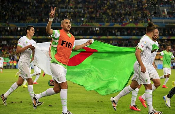 Algerian squad members celebrate at the end of their Group H football match against Russia at the Baixada Arena in Curitiba during the 2014 FIFA World Cup on June 26, 2014. Photo: Getty Images
