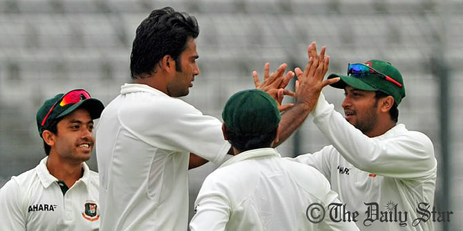 Bangladesh players celebrate Shahadat Hossain's picking of Zimbabwe's Hamilton Masakadza on third day of first Test match at Mirpur stadium on Monday. Photo: Firoz Ahmed