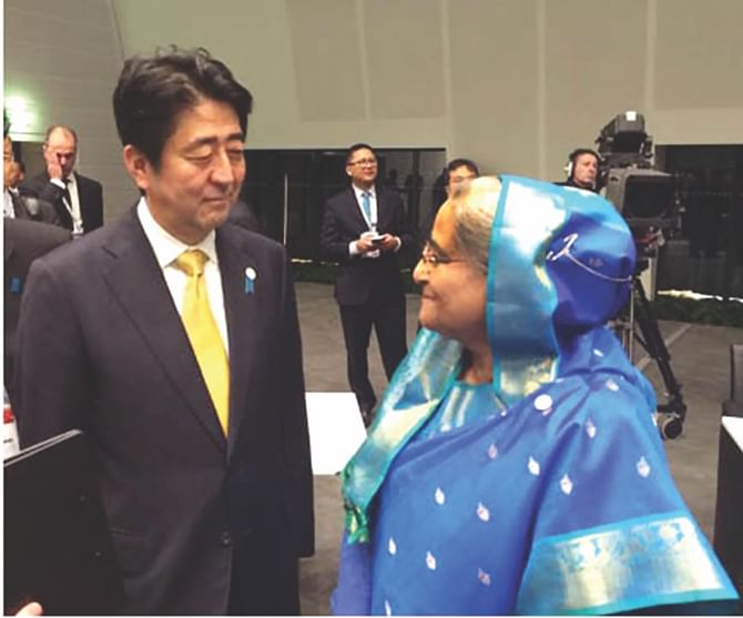 Prime Minister Sheikh Hasina meets Japanese Prime Minister Shinzo Abe, at Milano Congressi convention centre on the sidelines of 10th ASEM Summit in Italy yesterday. Photo: PID