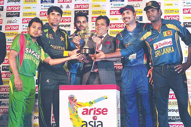 The five captains pose for a photo with the Asia Cup on the eve of the premier cricket championship of this region at the Pan Pacific Sonargaon Hotel yesterday. The tournament kicks off at 2pm today with the opening match between holders Pakistan and Sri Lanka at the purpose-built Fatullah Stadium.  Photo: Firoz Ahmed