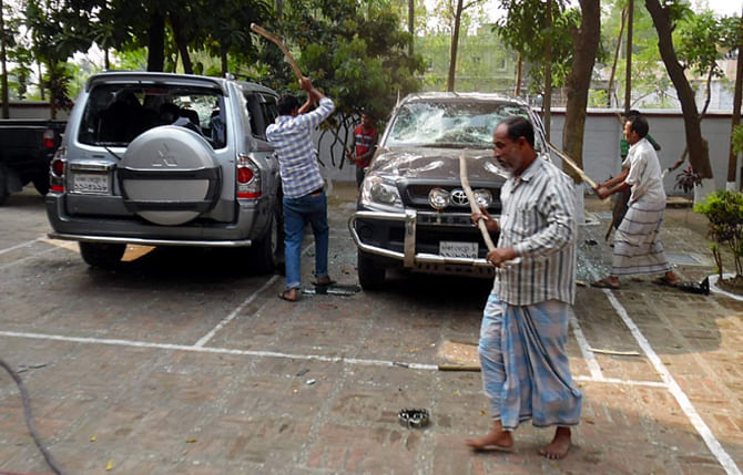 People of Phulbari area in Dinajpur vandalise two vehicles of Asia Energy Corporation (Bangladesh) in front of the company's local office in Phulbari municipality area yesterday, protesting the visit of Gary Lye, chief executive officer (CEO) of Asia Energy. Photo: Star