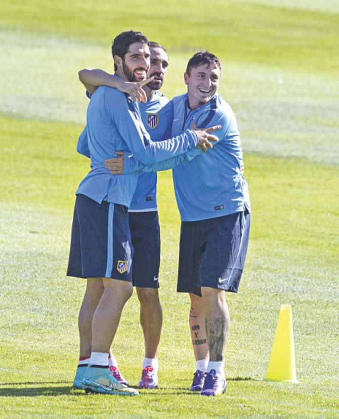(L-R) Atletico Madrid players Raul Garcia, Juanfran and Cristian Rodriguez share a light moment during training at the Cerro del Espino Stadium yesterday. Photo: AFP