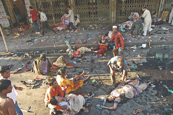 After the hail of grenades on an Awami League rally on Bangabandhu Avenue a few rush to help as the injured regain consciousness surrounded by bodies on this day 10 years ago. Photo: File
