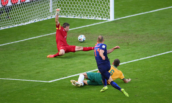 Arjen Robben of the Netherlands shoots and scores his team's first goal past goalkeeper Mathew Ryan of Australia during the 2014 FIFA World Cup Brazil Group B match between Australia and Netherlands at Estadio Beira-Rio on June 18, 2014 in Porto Alegre, Brazil. Photo: Getty Images