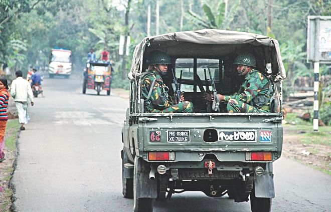 Troops patrol Bakerganj upazila in Barisal yesterday morning.  The army has been deployed to help law enforcers maintain law and order before and during the February 19 upazila polls.   Photo: Star