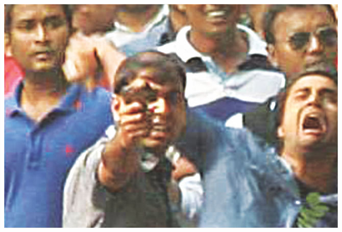 A BCL activist brandishing a gun during an attack by the pro-ruling party student body on members of the BNP.  Photo: Star