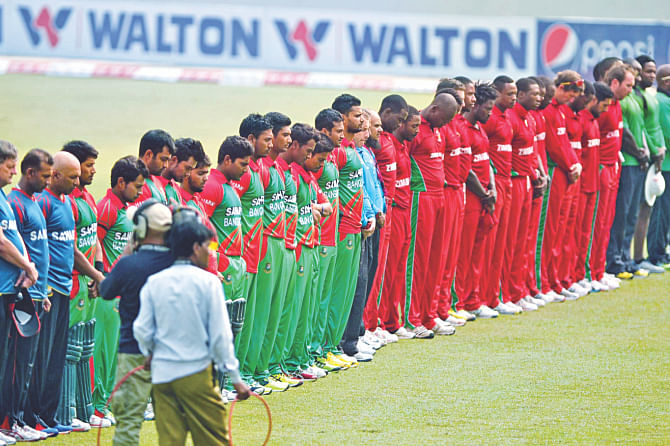 Bangladesh and Zimbabwe players observe a minute's silence before the start of the fourth ODI in Mirpur yesterday as mark of respect to Australian cricketer Phillip Hughes, who passed away tragically at the age of 25 on Thursday. PHOTOS: STAR/INTERNET