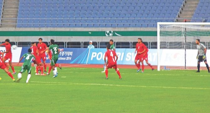 A goalmouth action during yesterday's Asian Games football match between Bangladesh and Afghanistan at the Munhak Stadium in Incheon in South Korea. PHOTO: ANISUR RAHMAN
