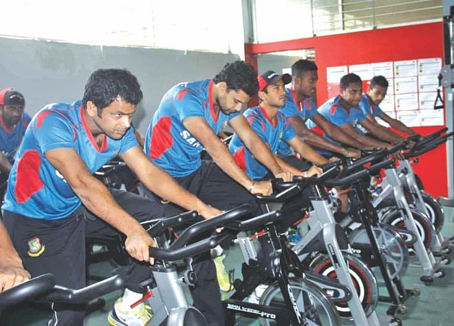 Bangladesh national players crunch in some valuable gym-time at the indoor facilities of Sher-e-Bangla National Stadium yesterday afternoon. National selectors are expected to announce the final squad for the West Indies series before Eid. PHOTO: STAR