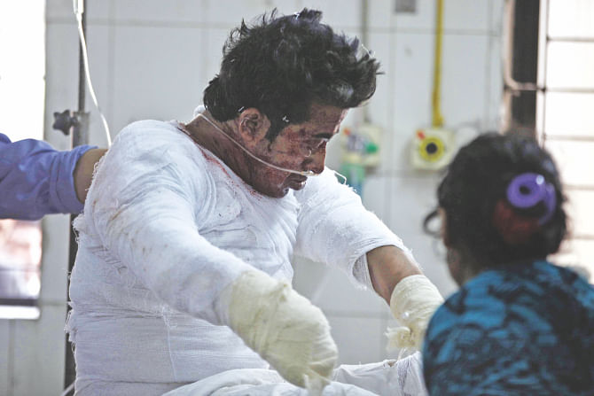 Bappy wrapped in bandage at the burn unit of the DMCH yesterday. The Chhatra Dal leader lost his right hand and injured his nephew and niece while the bomb he allegedly was making went off at his Lalbagh home. Photo: Star