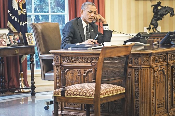 US President Barack Obama speaks on the phone with King Abdullah II of Jordan from his Oval office. Photo: Afp, Ap