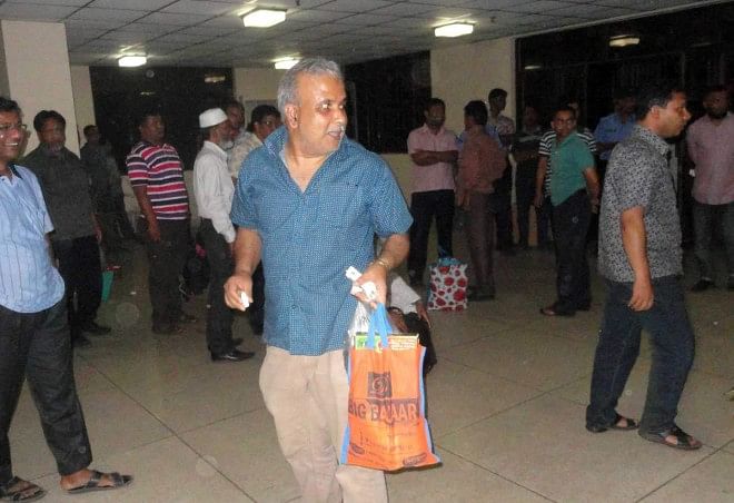 Officials of Barapukuria Coal Mining Company Ltd come out of the office building in a happy mood on Wednesday night as the miners and workers withdrew their agitation programme that included confining the officials since Tuesday morning. PHOTO: STAR