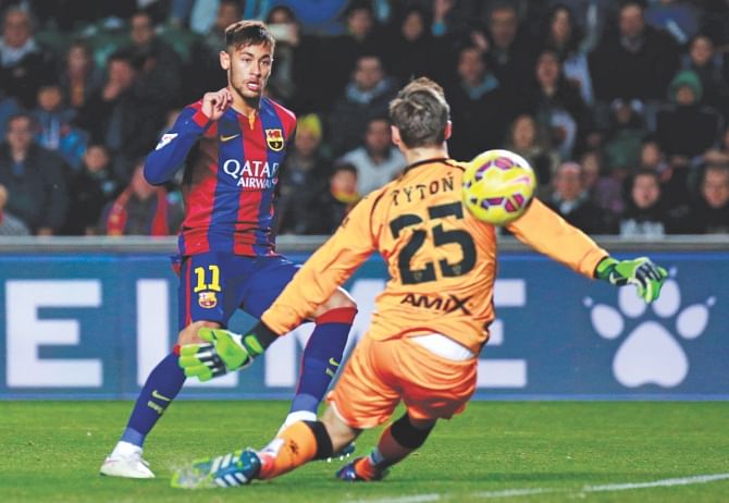 Barcelona forward Neymar slots home one his two strikes against Elche during their Primera Liga game yesterday. Photo:AFP
